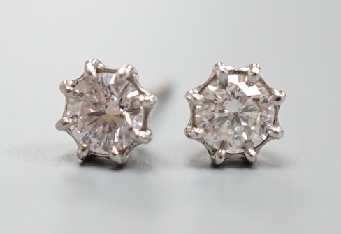 A pair of 750 white metal and solitaire diamond set ear studs